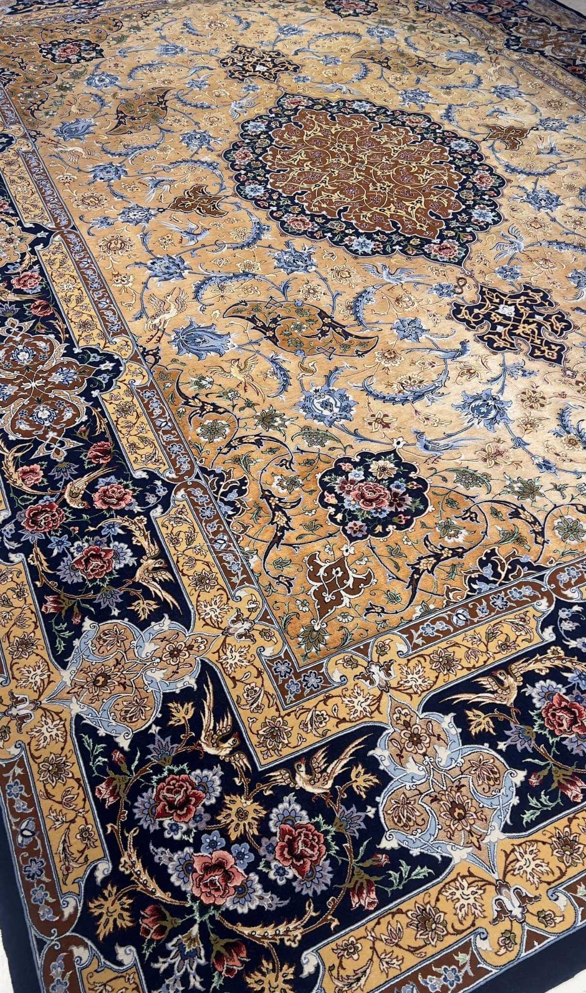 "Large Persian rug featuring 70% silk and wool with a bold central medallion on a golden background."